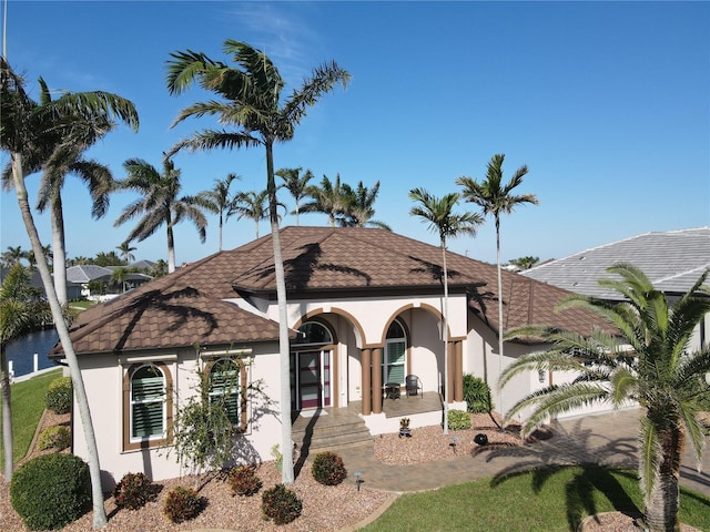 view of front of property featuring a porch, a garage, and stucco siding