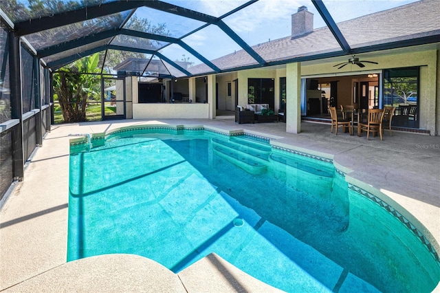 pool with glass enclosure, outdoor lounge area, a ceiling fan, and a patio