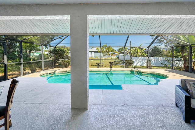 view of swimming pool with a patio, a lanai, and a fenced in pool