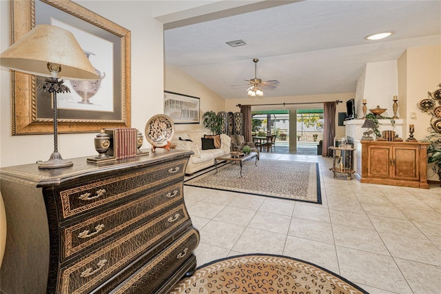 interior space featuring light tile patterned floors, ceiling fan, vaulted ceiling, and visible vents