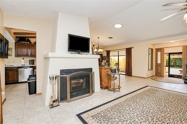 living area featuring light tile patterned floors, a large fireplace, ceiling fan with notable chandelier, visible vents, and baseboards