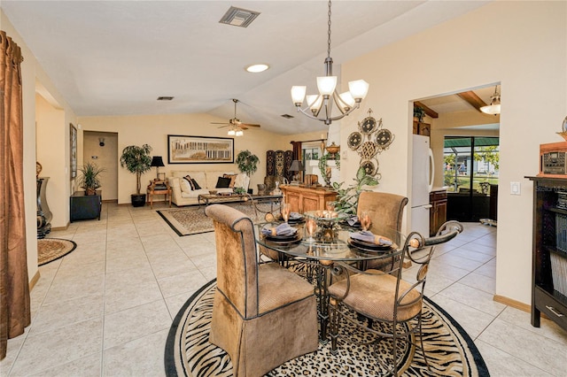 dining area featuring vaulted ceiling, light tile patterned floors, ceiling fan with notable chandelier, and visible vents