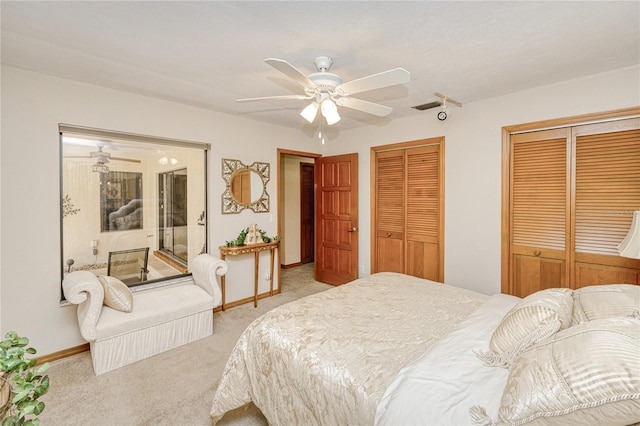 bedroom featuring light carpet, ceiling fan, baseboards, and multiple closets