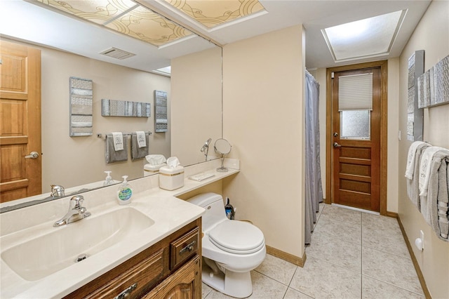 bathroom with tile patterned flooring, toilet, visible vents, vanity, and baseboards