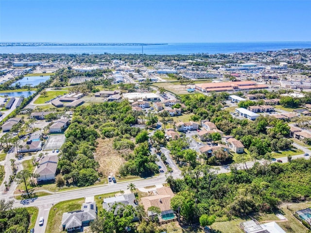 drone / aerial view featuring a water view and a residential view