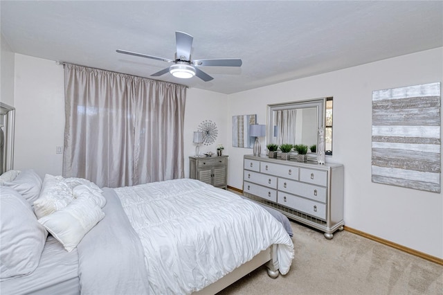 bedroom with baseboards, a ceiling fan, and light colored carpet