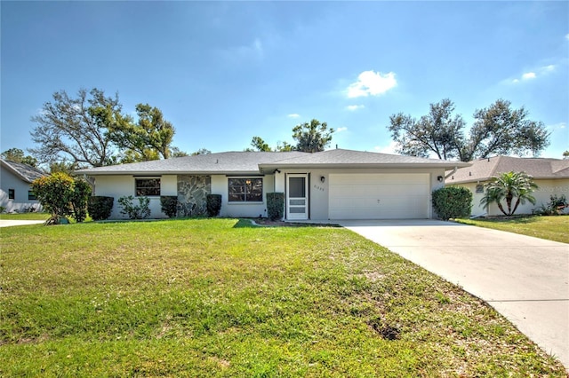 single story home featuring a garage, driveway, a front lawn, and stucco siding