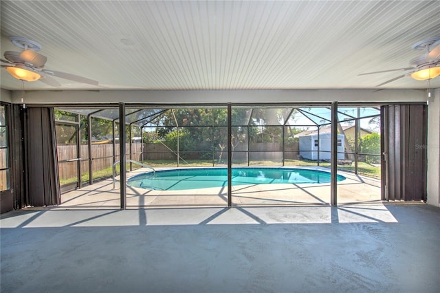 view of pool featuring a lanai, a patio area, a fenced backyard, and a ceiling fan