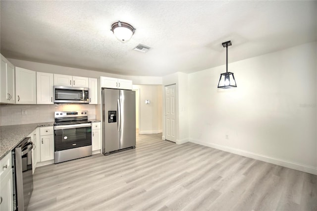 kitchen featuring stainless steel appliances, tasteful backsplash, visible vents, light wood-style flooring, and white cabinetry