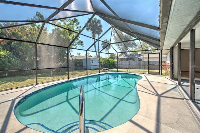 view of pool featuring glass enclosure, a patio area, fence, and a fenced in pool