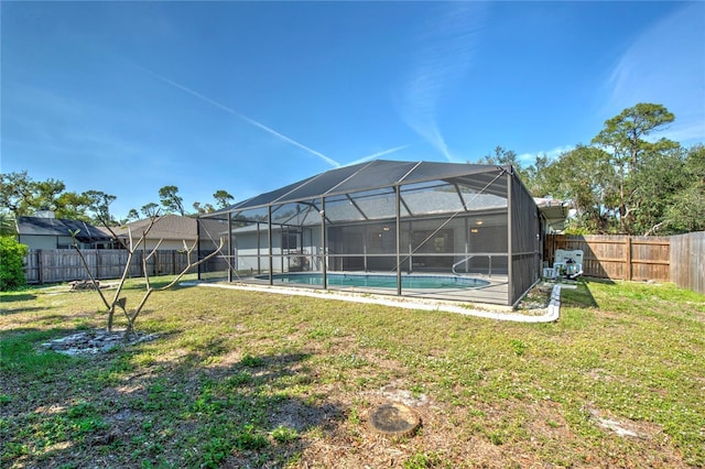 exterior space with a lanai, a fenced backyard, a fenced in pool, and a yard