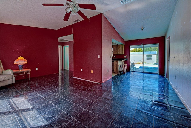 unfurnished living room with lofted ceiling, visible vents, a ceiling fan, a textured ceiling, and baseboards