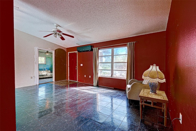 interior space featuring lofted ceiling, arched walkways, a textured ceiling, and a textured wall