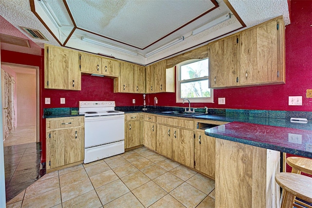 kitchen with a textured ceiling, a sink, electric stove, a tray ceiling, and dark countertops