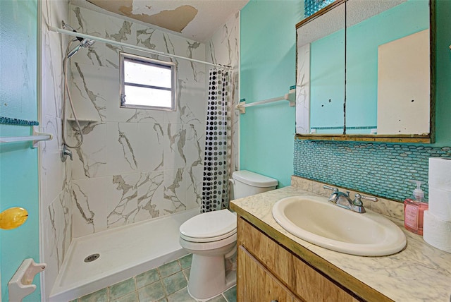 bathroom featuring a stall shower, vanity, and toilet