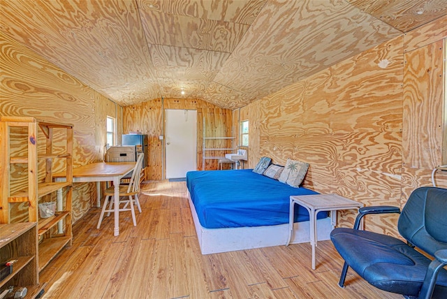 bedroom featuring lofted ceiling and wood finished floors