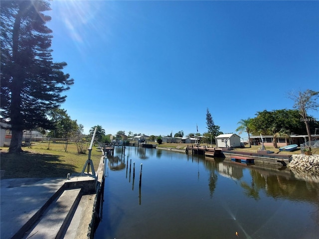 dock area featuring a water view and fence