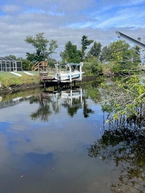 property view of water featuring a boat dock and boat lift