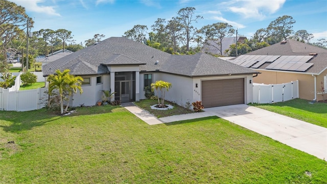 single story home featuring a garage, a front yard, fence private yard, and a gate