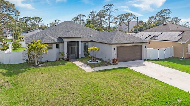 ranch-style house featuring a front lawn, an attached garage, fence private yard, and a gate