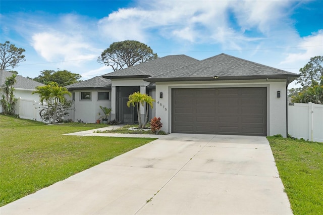 view of front of home with stucco siding, a shingled roof, an attached garage, driveway, and a front lawn