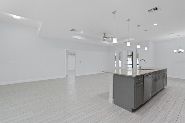 kitchen with a tray ceiling, open floor plan, visible vents, and dishwasher