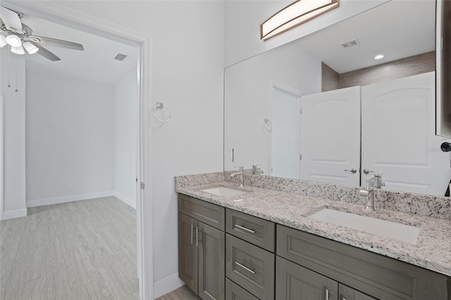 bathroom with visible vents, a sink, and wood finished floors