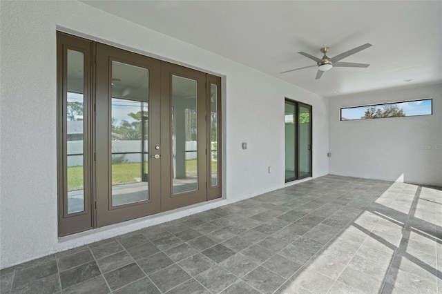 exterior space with stone finish floor, french doors, and ceiling fan