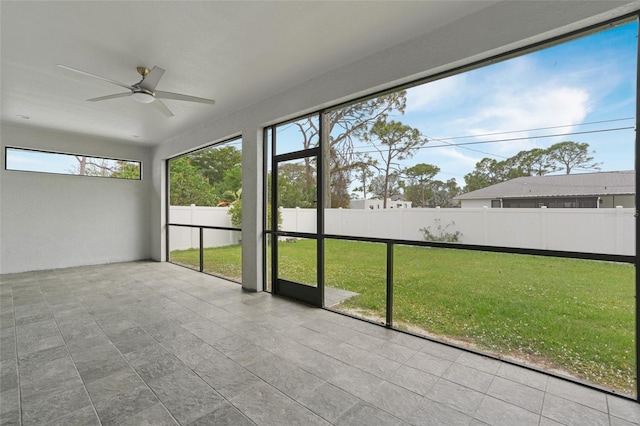 unfurnished sunroom with a ceiling fan