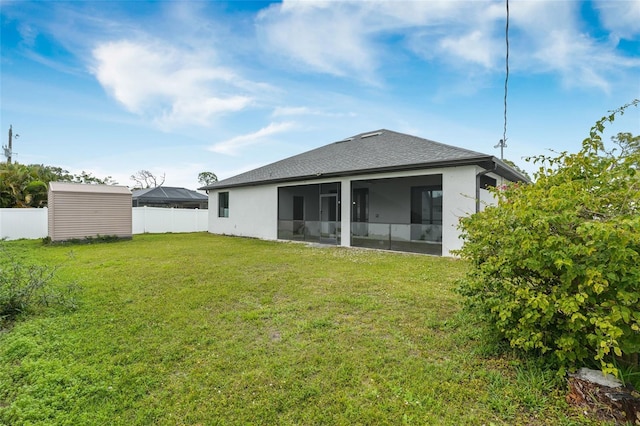 back of property featuring a shingled roof, fence, a sunroom, a yard, and stucco siding