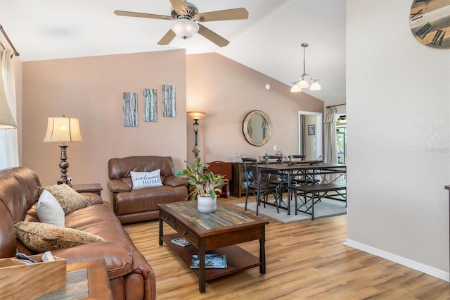 living area with vaulted ceiling, baseboards, light wood-type flooring, and ceiling fan