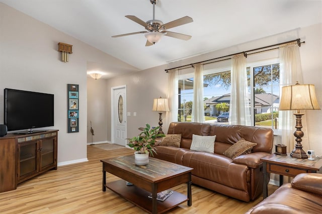 living area featuring light wood-style flooring, baseboards, ceiling fan, and vaulted ceiling