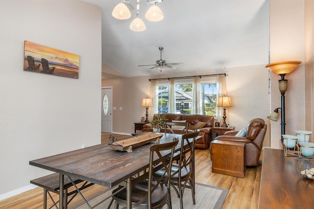 dining area with lofted ceiling, baseboards, light wood-style floors, and a ceiling fan