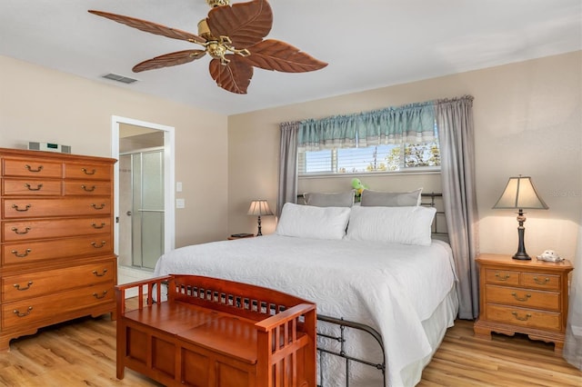 bedroom featuring visible vents, light wood-style floors, and a ceiling fan