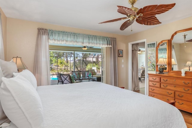 bedroom with access to exterior, wood finished floors, and a ceiling fan