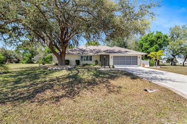 single story home featuring a front yard, a garage, and driveway