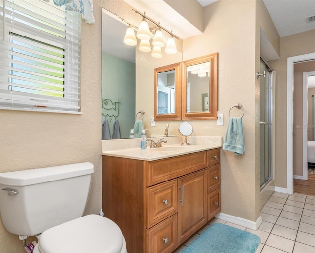 full bathroom with vanity, visible vents, a stall shower, tile patterned floors, and toilet