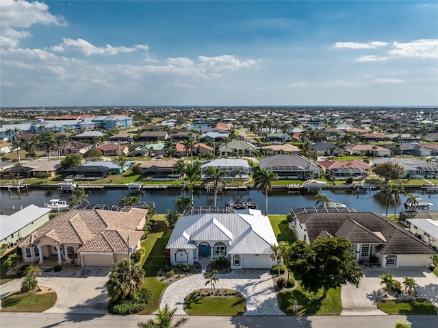 drone / aerial view with a water view and a residential view