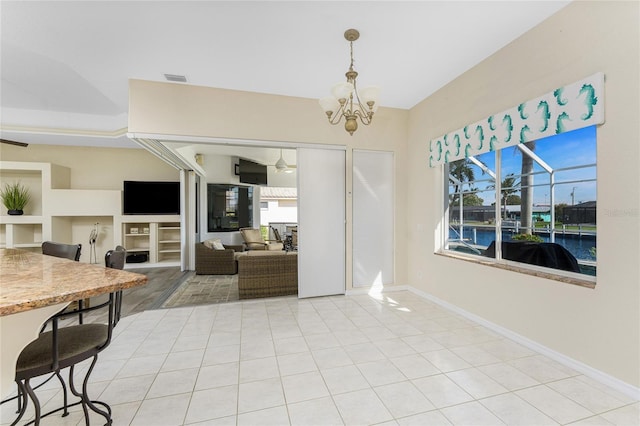 interior space with light tile patterned floors, baseboards, visible vents, and a chandelier