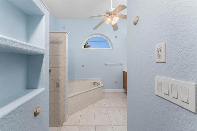 bathroom with a ceiling fan, baseboards, a bath, and tile patterned floors