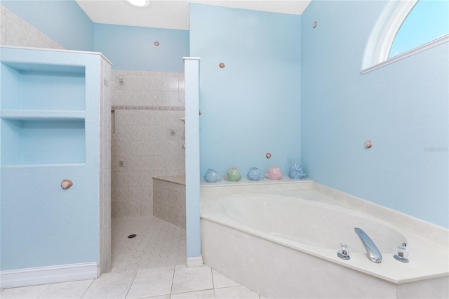 full bath with tile patterned flooring, a garden tub, baseboards, and tiled shower