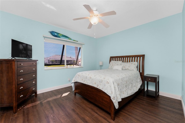 bedroom featuring a ceiling fan, baseboards, and dark wood-type flooring