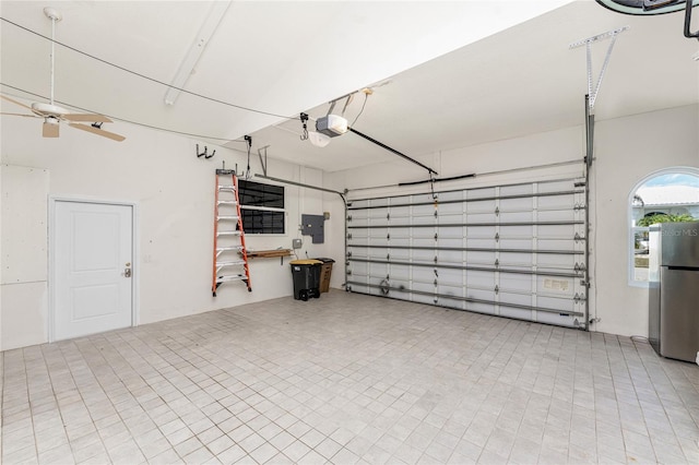 garage featuring ceiling fan, electric panel, a garage door opener, and freestanding refrigerator