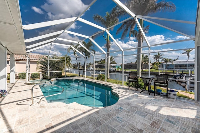 view of pool with a patio, a water view, a lanai, and a pool with connected hot tub