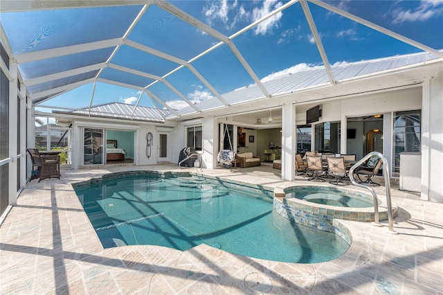 view of swimming pool featuring a pool with connected hot tub, a patio, a lanai, and an outdoor hangout area