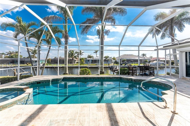 view of pool with a patio area, a lanai, and a water view