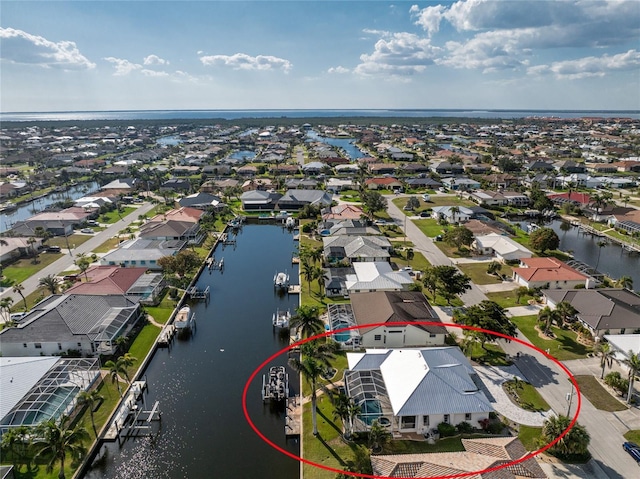 birds eye view of property with a residential view and a water view