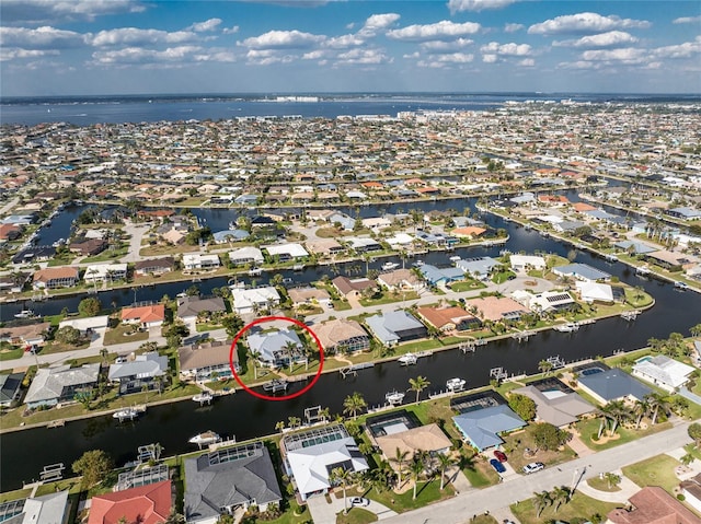 drone / aerial view with a residential view and a water view