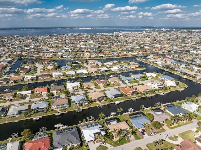 drone / aerial view with a water view and a residential view