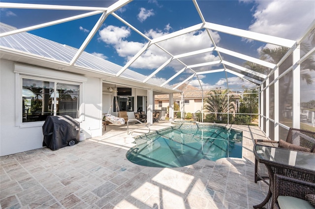 view of pool with a patio, area for grilling, a lanai, and a pool with connected hot tub